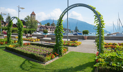 park landscape Spiez, flower and vegetable beds, overgrown archways, switzerland