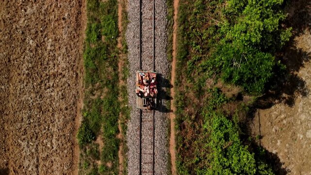 Drone aerial view of people riding the bamboo train in Battambang, Cambodia