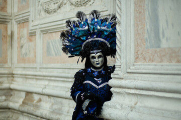 Venice, Italy - February 9, 2026 - People dressed in masks for the Venice Carnival have their photos taken by tourists