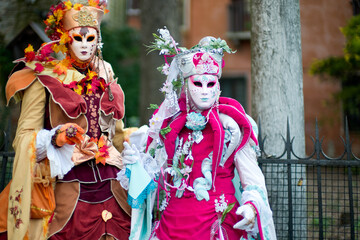Obraz premium Venice, Italy - February 9, 2026 - People dressed in masks for the Venice Carnival have their photos taken by tourists