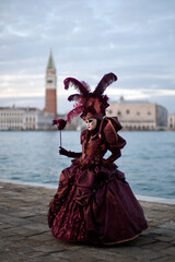 Obraz premium Venice, Italy - February 9, 2026 - People dressed in masks for the Venice Carnival have their photos taken by tourists