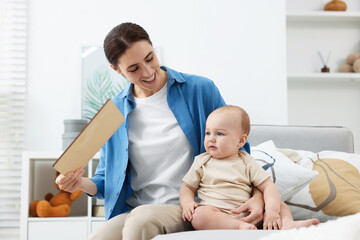 Obraz premium Mother with her cute baby on daybed at home