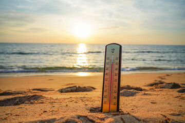 Thermometer on sunset sea beach in tropical. Extremely hot day. Thermometer measuring air temperature. Heat wave weather. Hot weather, drought. Abnormally temperature, extreme heat in Europe. Sunburn. © MaxSafaniuk