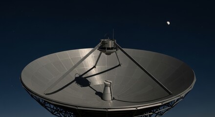 Close-up of a large satellite dish against dark sky