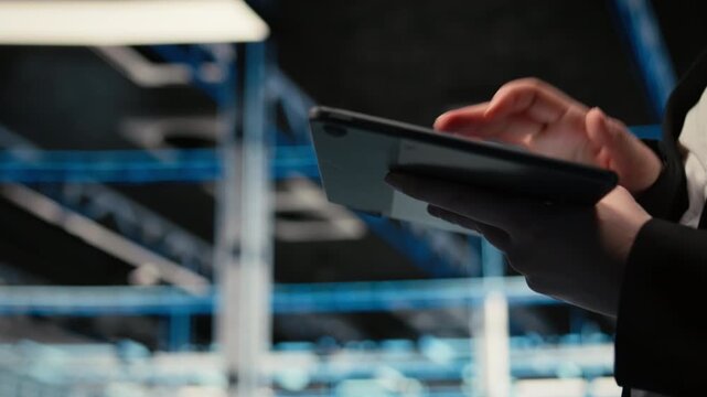 Troubleshooting, tablet closeup and admin in data center fixing supercomputers connectivity issues. Analyzing system logs, device screen and worker in server hub resolving electronics errors, camera A