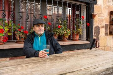Senior man drinking water for hydration and well-being