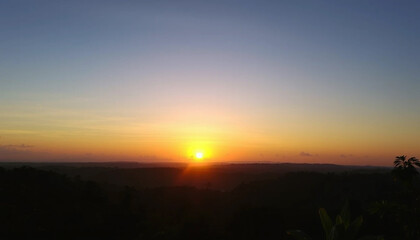 Fototapeta premium Calm radiant sunset above jungle sky