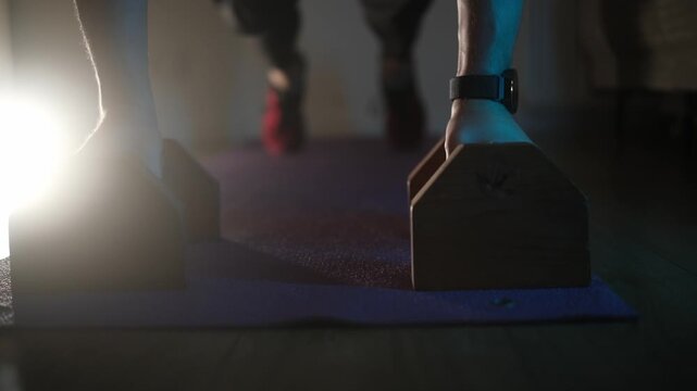 Fit Male Athlete Trains With Floor Pushups On Parallel Bars At Home In The Evening With Dramatic Light