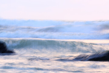 Obraz premium Long exposure abstract of waves at the beach during monsoon season