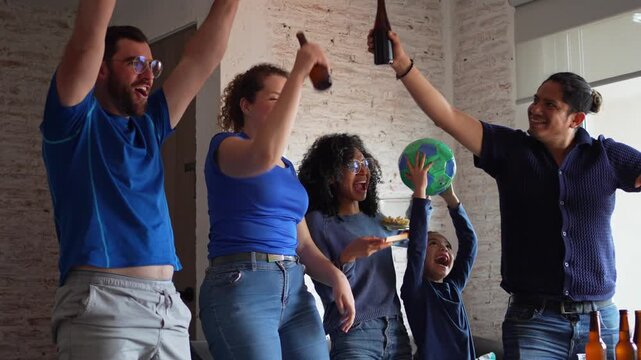 Family and friends celebrating a football soccer moment at home while eating pizza and drinking beverages together, smiling and cheering in front of the TV. Sports joy, friendship, home gathering