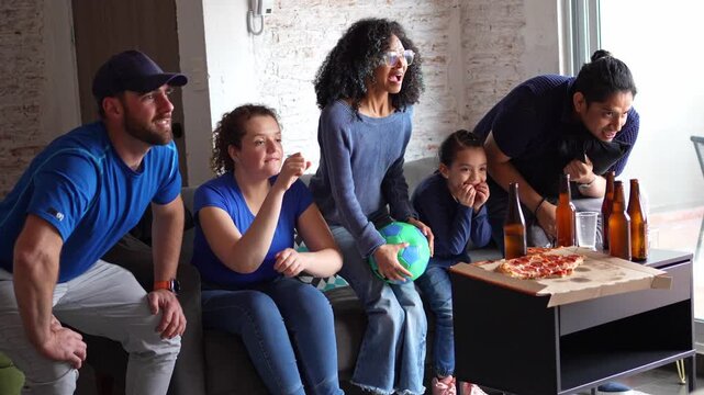 Family and friends on the edge of their seats watching a soccer football match, anticipating a goal attempt, then reacting with disappointment after the missed shot. Sports tension, game night emotion