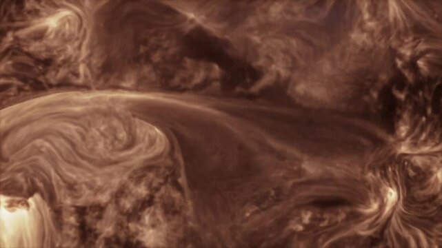 A close-up view of swirling plasma on the Sun's surface, showing intricate magnetic field lines and energetic activity in shades of brown and orange.