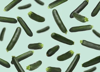 Fotobehang Eten Fresh zucchinis falling against light turquoise background  © New Africa