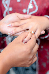 Woman receiving engagement ring in intimate moment with loved one