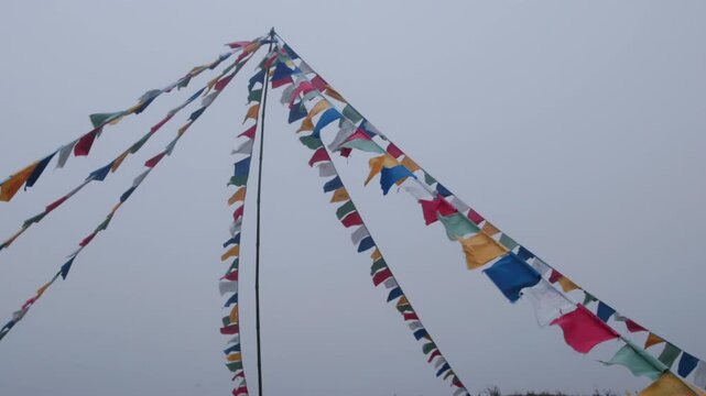 Prayer flags are strung up on a hilltop in Sapa, L&agrave;o Cai, Vietnam, to spread positive energy and good fortune. The flags are colorful and vibrant, even in the thick fog.