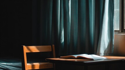 Open book on wooden table in room with sunlight coming through window