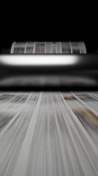 Close up of newspapers rolling rapidly through metallic cylinders of a rotary printing press in a seamless 3D animation, conceptualizing the fast pace of mass media and publishing industries.