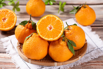fresh ponkans tangerines on wooden table.