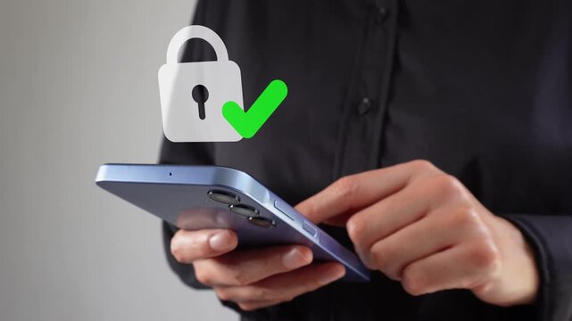 Executive looking at her cell phone screen with an animation of a padlock with a check mark.