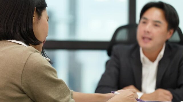 Serious Business Discussion With Documents in Modern Office