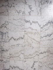 Obraz premium Top view of white marble floor tiles with grey veins. Natural stone texture pattern for architectural design, interior surface, and luxury background.