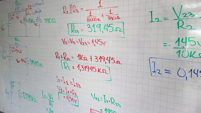 Hand-written circuit diagrams and mathematical formulas on a whiteboard. Concepts of resistance, voltage, and current for physics education and engineering studies.