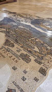 Madaba Mosaic Map of the Holy Land inside Saint George&rsquo;s Church in Madaba, Jordan, showing intricate byzantine floor artwork and stone tiles, cinematic handheld panning vertical view