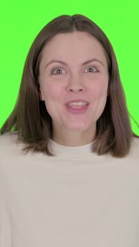 Young Woman Talking on Online Video Call on Green Background, vertical video
