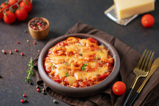 Karides guvec. Turkish cuisine. Baked shrimps with vegetables, tomato sauce and melted cheese
