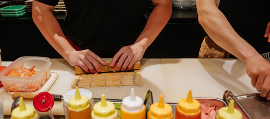 chef's hands, Japanese food preparation - sushi, chef, Maki roll preparation © Anastasia