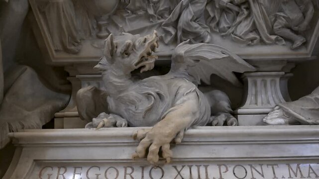 Close up of the heraldic marble dragon carved at the base of the funeral monument of Pope Gregory XIII by Camillo Rusconi inside Saint Peters Basilica