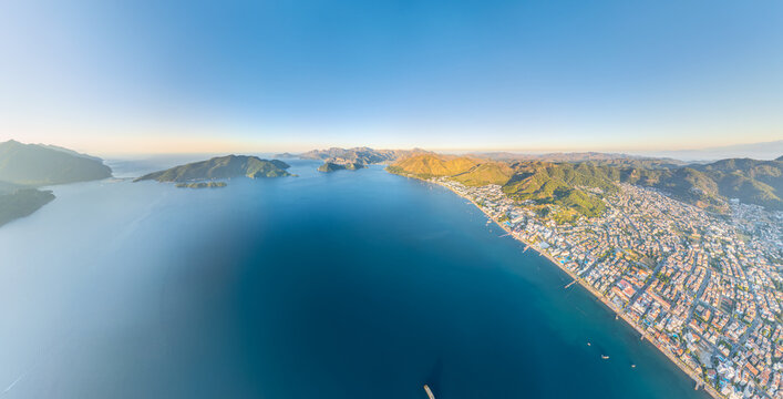 Marmaris, Turkey. Panoramic aerial view of city, mountains, coastline, bay with Cennet and Kechi Islands at morning. Island landscape from above. Aerial view.