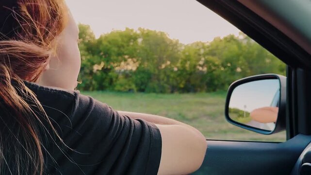 girl summer trip by car, woman stuck hand out window smiling, happy family, cinematic nature, girl looking into octo car, fresh breeze through fingers, sun glare hair, breathe nature, drive outdoors