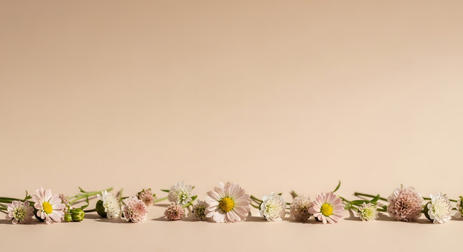 A row of flowers arranged on a flat surface from a straight-on viewpoint