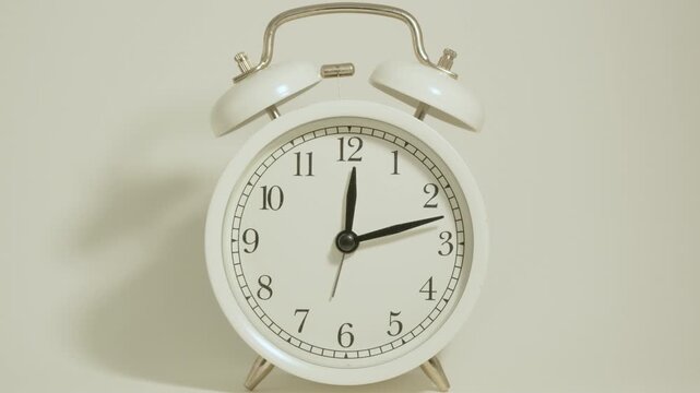 Tme lapse video of a clock time passing over a day to night on white background.