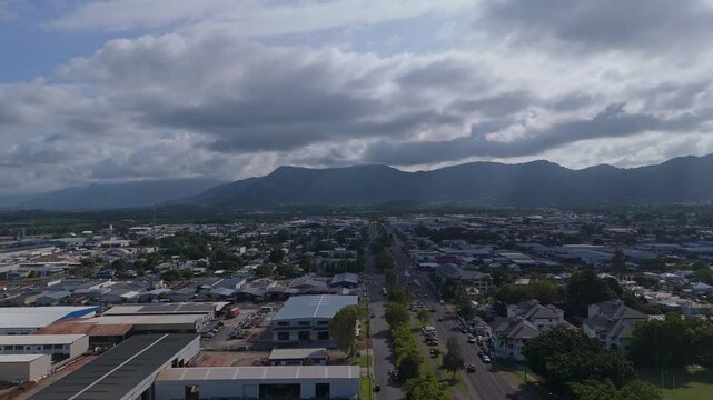 Cairns Suburbs with Tropical Mountains Under Cloudy Sky