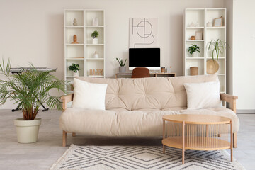 Fototapeta premium Interior of living room with sofa, coffee table and workplace