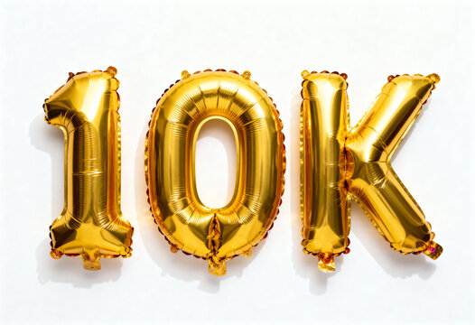 Golden 10K balloons arranged in a row on a white background for celebration