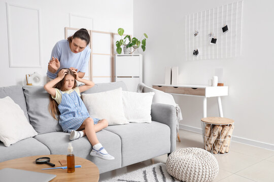 Little girl with pediculosis and her mother at home