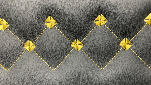Beautiful thread stitching and embroidery on the black leather.