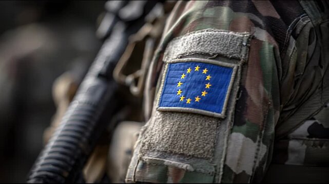 european union flag patch on the shoulder of an army soldier, holding a rifle