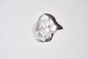 Glycerin gel texture. Transparent serum drop on white background. Liquid gel moisturizer with bubbles macro.