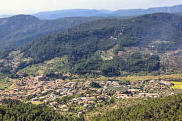 Naklejka premium Aerial view at Valldemossa a village in a valley by the mountains on Mallorca