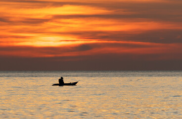 A man is in a kayak on a lake