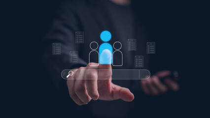 Fototapeta premium Businessman select candidate profile on virtual interface with search bar and digital resume, representing recruitment process, talent acquisition, human resources management, and employee concept.