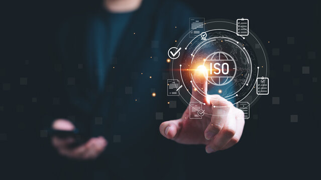 Businessman touch virtual ISO certification interface with global network and digital checklist symbols, representing quality management, compliance standard, audit process and global accreditation.