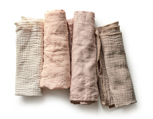 Four rolled linen napkins in pastel colors isolated on white background