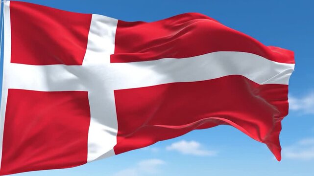 The national flag of Denmark waving in the wind against a blue sky