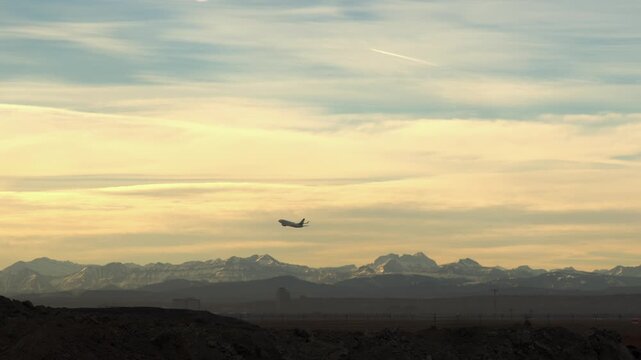 Commercial jet airliner takes off from YYC airport with Rocky Mountains