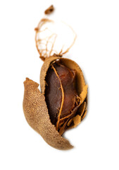 A brown fruit with a hole in it